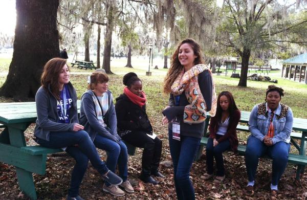 Junior Megan Thompson (second from left) participates in her family group.