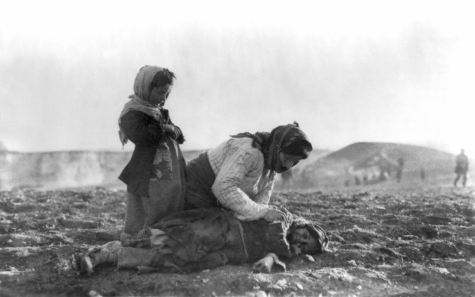 An Armenian woman kneels beside her dead child. Photo via Wikimedia Commons