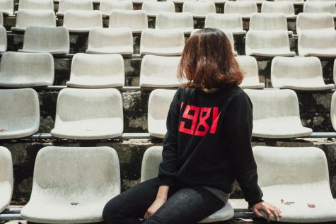 Photo of Woman Sitting on Gray Bleacher Chair by Duong Nhan