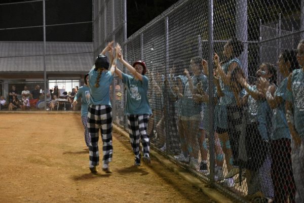 Classmates cheer each other on during class softball games.